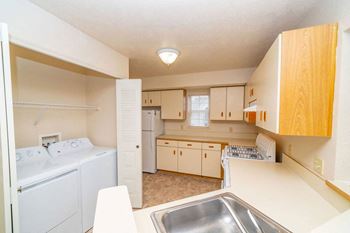 One Bedroom Kitchen with a washer and dryer at Trillium Pointe Apartment Homes in Jackson, MI