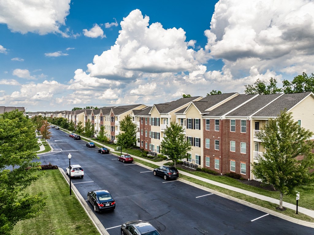 an aerial view of an apartment complex with cars parked on a street at The Avenue at Polaris Apartments, Ohio