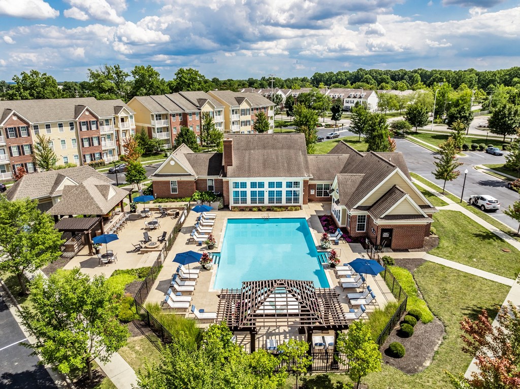 an aerial view of the resort style pool with lounge chairs around it at The Avenue at Polaris Apartments, Ohio