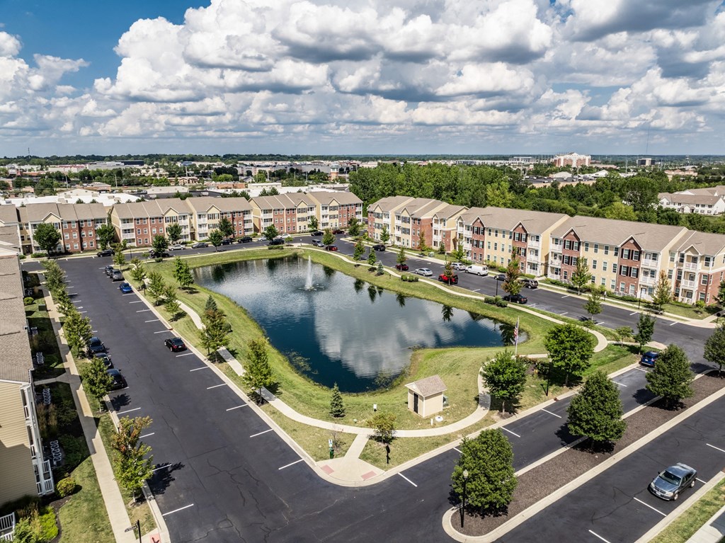 an aerial view of a pond in the middle of an apartment complex at The Avenue at Polaris Apartments, Ohio
