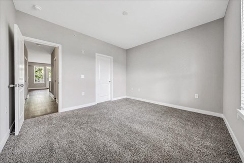 A spacious room with grey carpeting and white walls at The Retreat Apartments, Roanoke, 24019