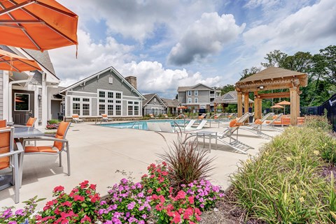 A pool area with a table and chairs and a gazebo at The Retreat Apartments, Roanoke, 24019