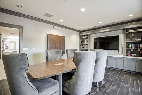 A modern dining room with grey chairs and a wooden table at The Retreat Apartments, Roanoke, 24019