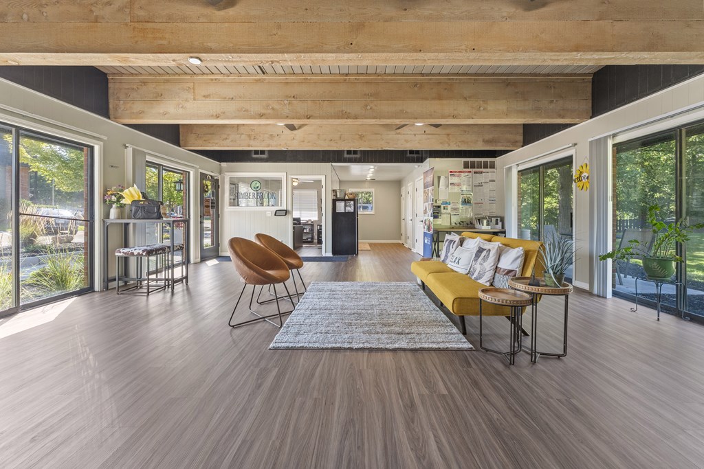 A modern living room with a wooden floor and a large window