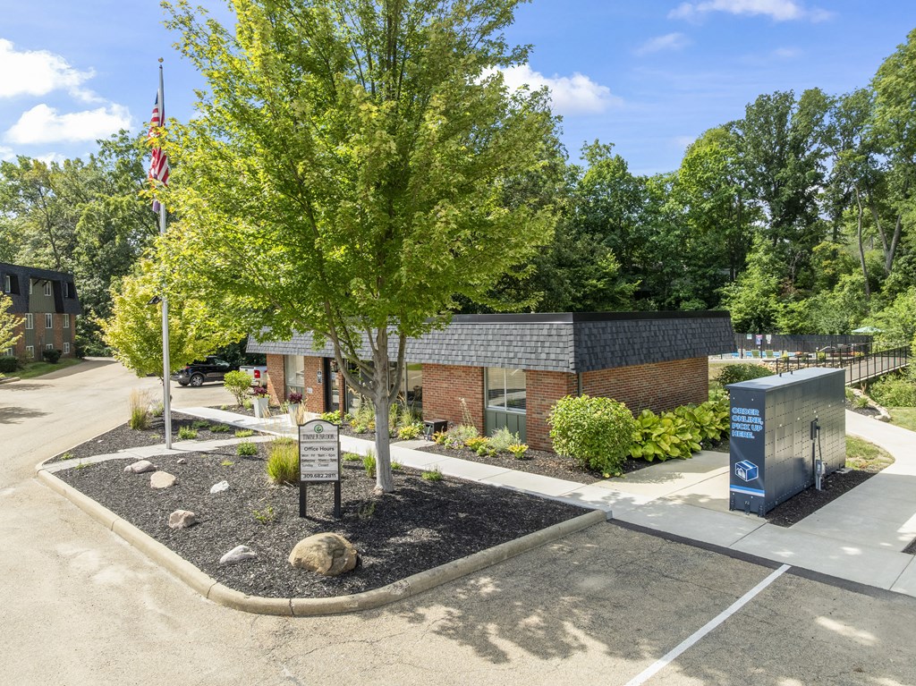 A small building with a flag on a pole in front of it