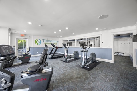 A gym with treadmills and elliptical machinesk at Timberlane Apartments, Peoria, Illinois