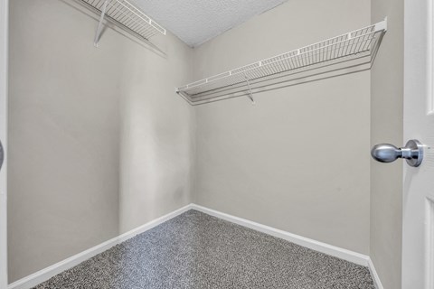 an empty closet with an open door and a shelf on the wall at Trophy Club at Bellgrade, Midlothian, VA, 23113
