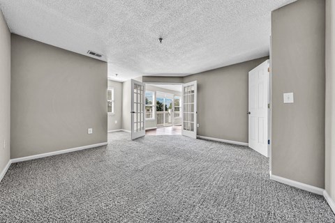 an empty living room and hallway with doors to a patio at Trophy Club at Bellgrade, Midlothian, VA, 23113