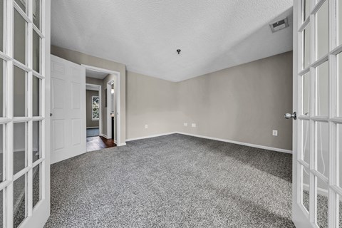 the living room of an empty house with white doors at Trophy Club at Bellgrade, Midlothian, VA, 23113