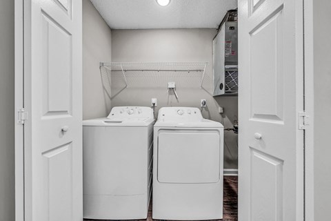 a washer and dryer in a laundry room with white appliances at Trophy Club at Bellgrade, Midlothian, VA, 23113