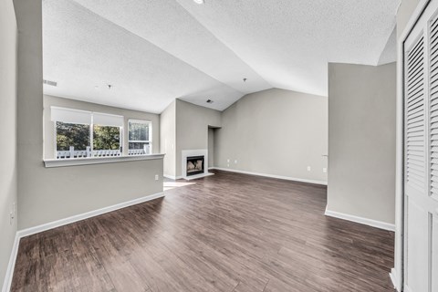 the living room and dining room of a new home with a fireplace at Trophy Club at Bellgrade, Midlothian, VA, 23113