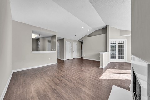 the living room and dining room of a new home with hardwood flooring at Trophy Club at Bellgrade, Midlothian, VA, 23113 