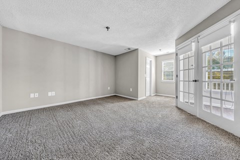 the living room and entryway of a house with white doors at Trophy Club at Bellgrade, Midlothian, VA, 23113