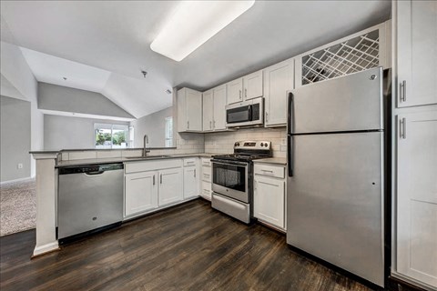a kitchen with stainless steel appliances and white cabinets at Trophy Club at Bellgrade, Midlothian, VA, 23113