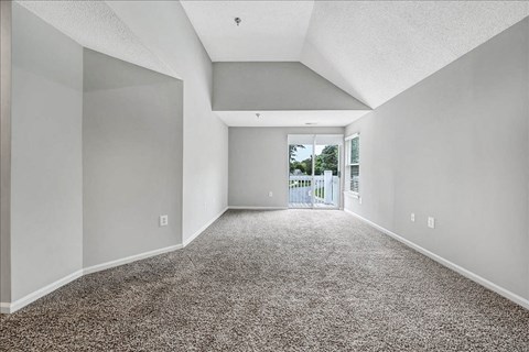 an empty living room with a door to a balcony at Trophy Club at Bellgrade, Midlothian, VA, 23113
