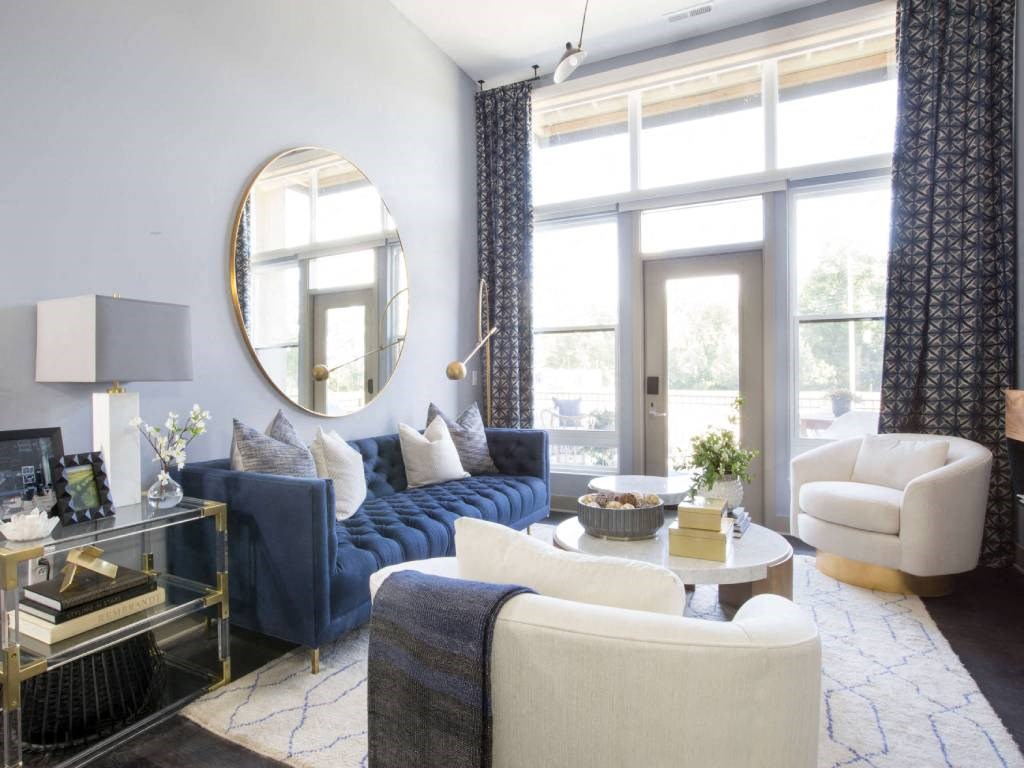 a living room filled with furniture and a large window  at Avant & Avant II, Carmel, IN