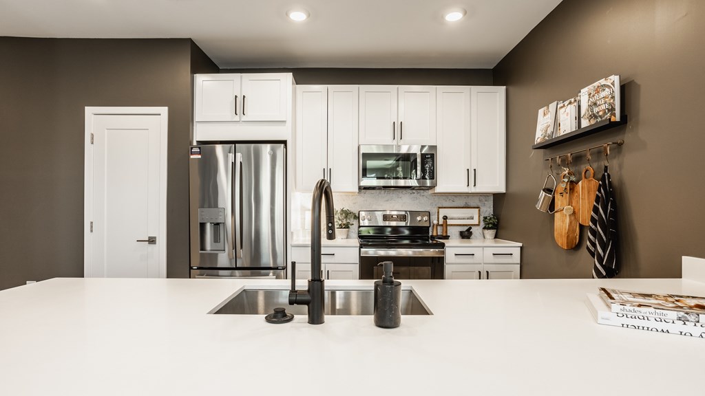 A modern kitchen with a white countertop and stainless steel appliances at Upper Vue Flats, Dublin
