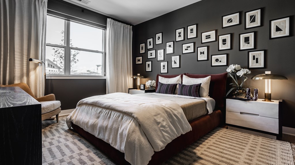 A bedroom with a large bed, a nightstand, and a window at Upper Vue Flats, Dublin