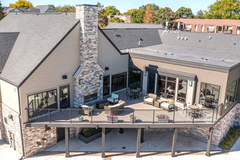 A house with a stone chimney and a covered patio.