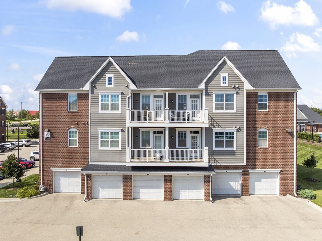 A large two-story house with a garage on the ground floor.