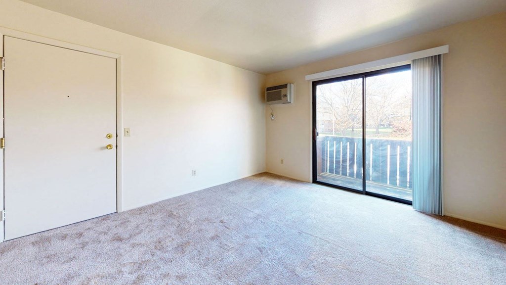 living room with a sliding door to a private balcony at Walnut Trail Apartments in Portage, MI 49002