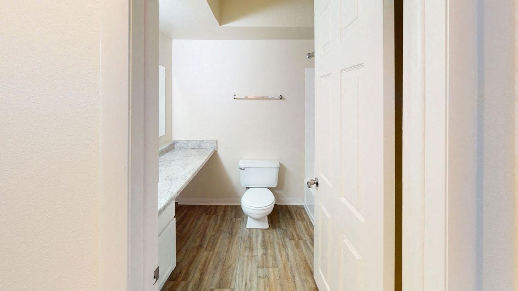 a renovated bathroom with a toilet and a sink at Walnut Trail Apartments in Portage, MI 49002
