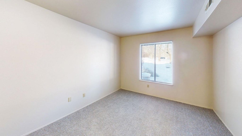 bedroom with a large window at Walnut Trail Apartments in Portage, MI 49002