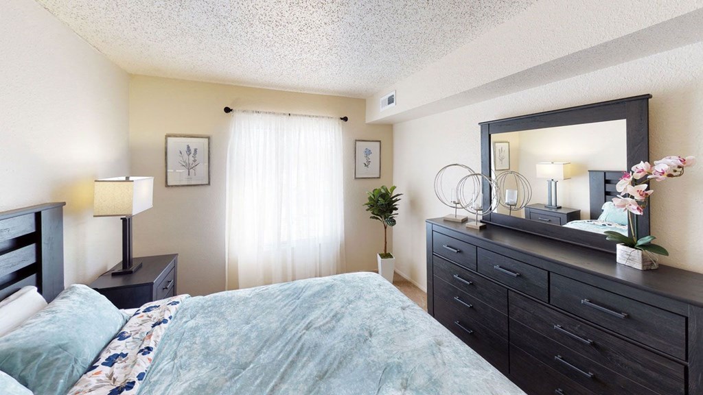 a bedroom with a large window a bedroom with a large window at West Wind Apartments in Fort Wayne, IN