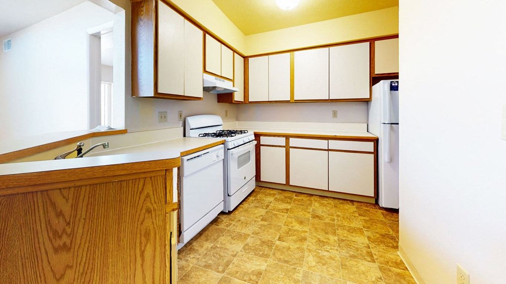 a kitchen with white appliances