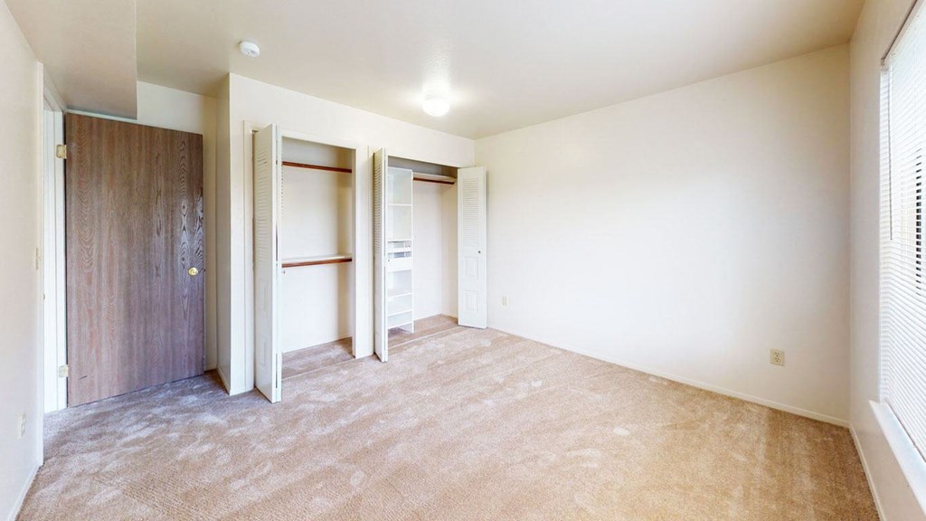 bedroom with doors to a large closet with organizers