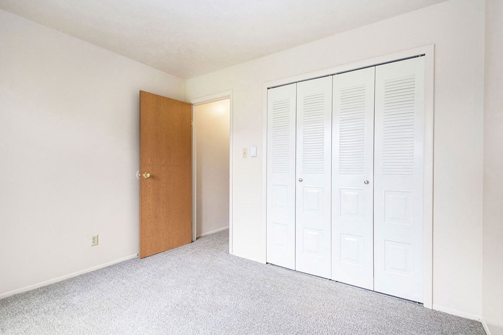 a bedroom with a large closet at Wingate Apartments, Kentwood, MI, 49512