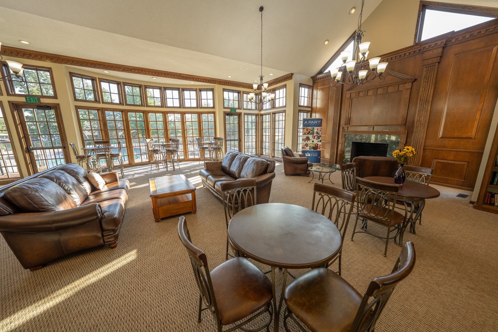 A large room with a fireplace and a chandelier.