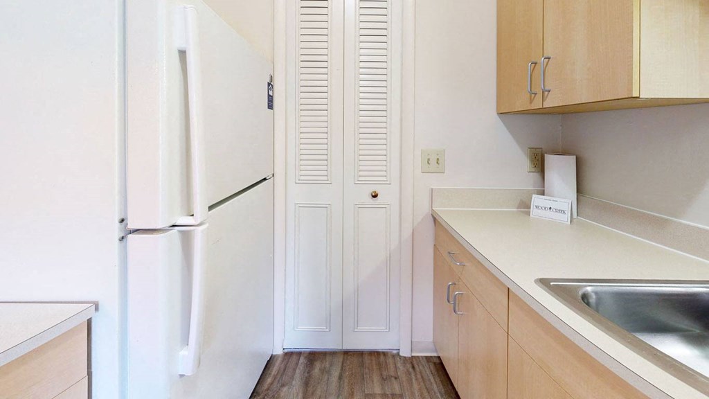 a kitchen with maple cabinetry  at Wood Creek Apartments, Kenosha, 53144