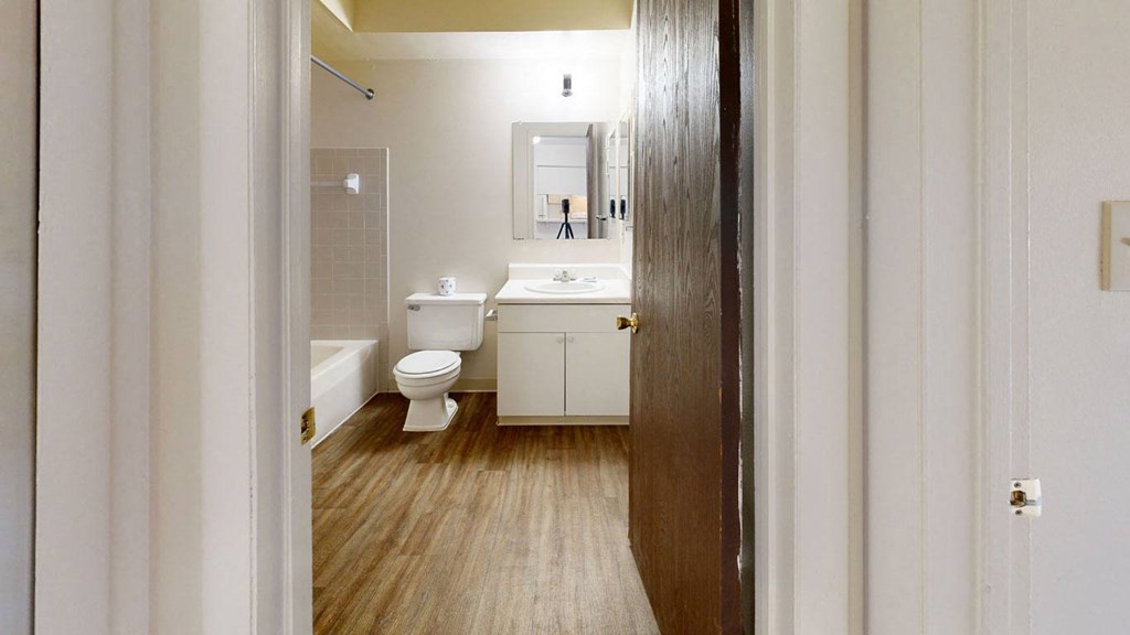 bathroom with a toilet and a sink  at Wood Creek Apartments, Kenosha, WI