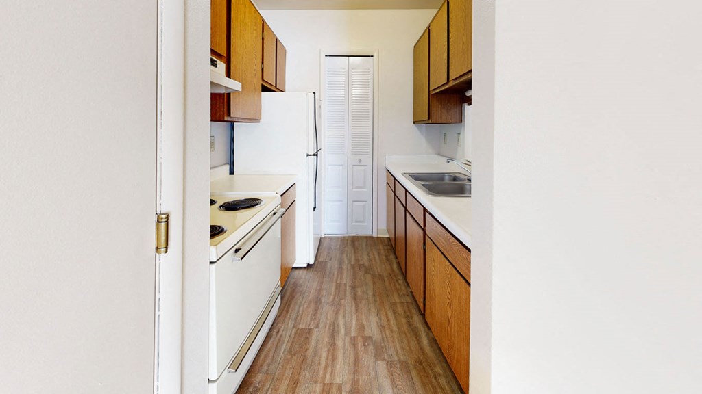 a kitchen with hard-surface floors and white appliances  at Wood Creek Apartments, Kenosha, 53144