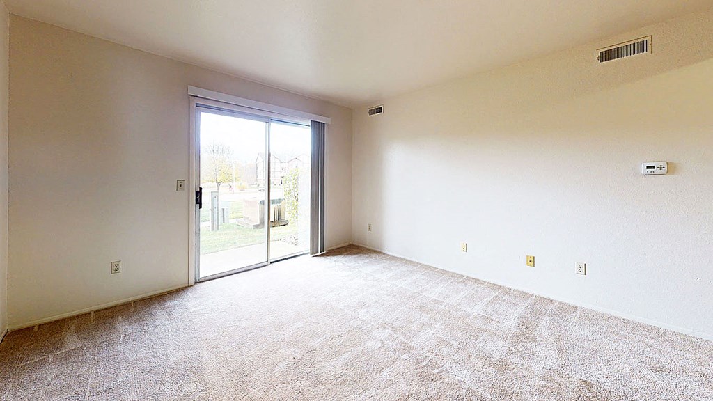 living room with a slider to private patio  at Wood Creek Apartments, Kenosha