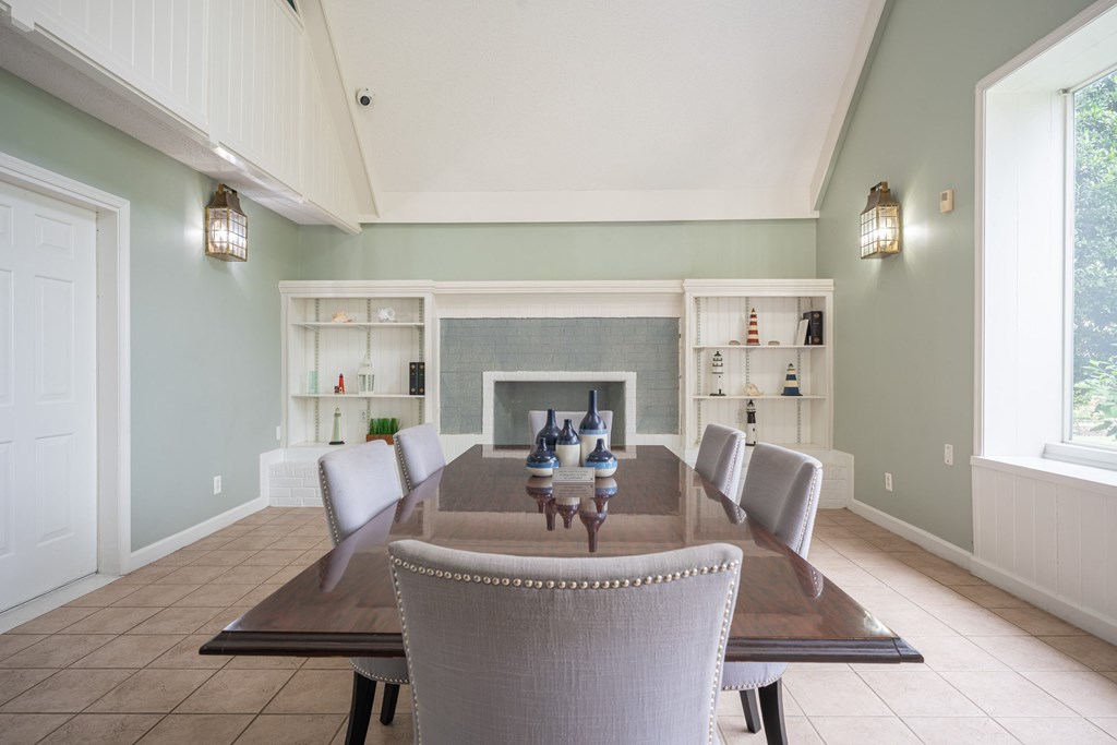 A dining room with a table and chairs.