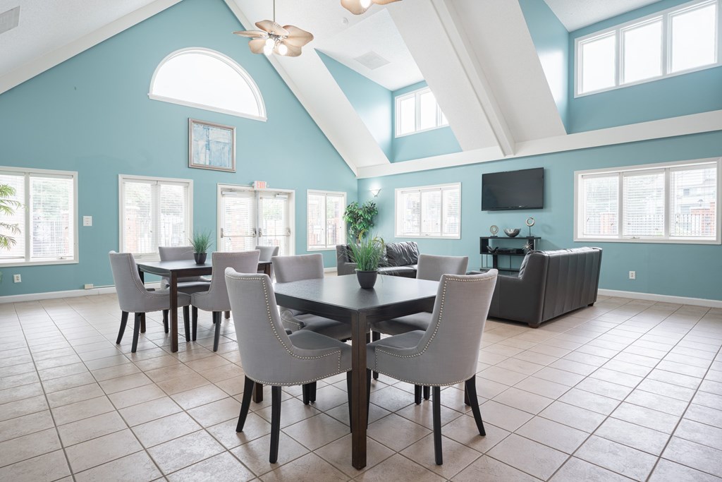 A dining room with a table and chairs.