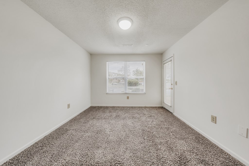 A room with a carpeted floor and a picture on the wall at WaterFront Apartments, Virginia Beach, 23453