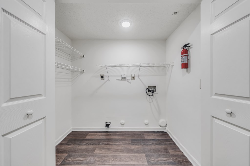 A white closet with a fire extinguisher on the wall at WaterFront Apartments, Virginia Beach, 23453