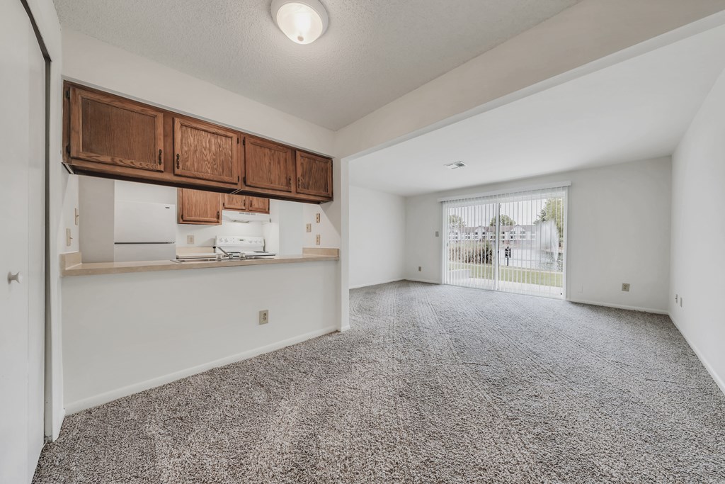 A room with a grey carpet and white walls at WaterFront Apartments, Virginia Beach, 23453
