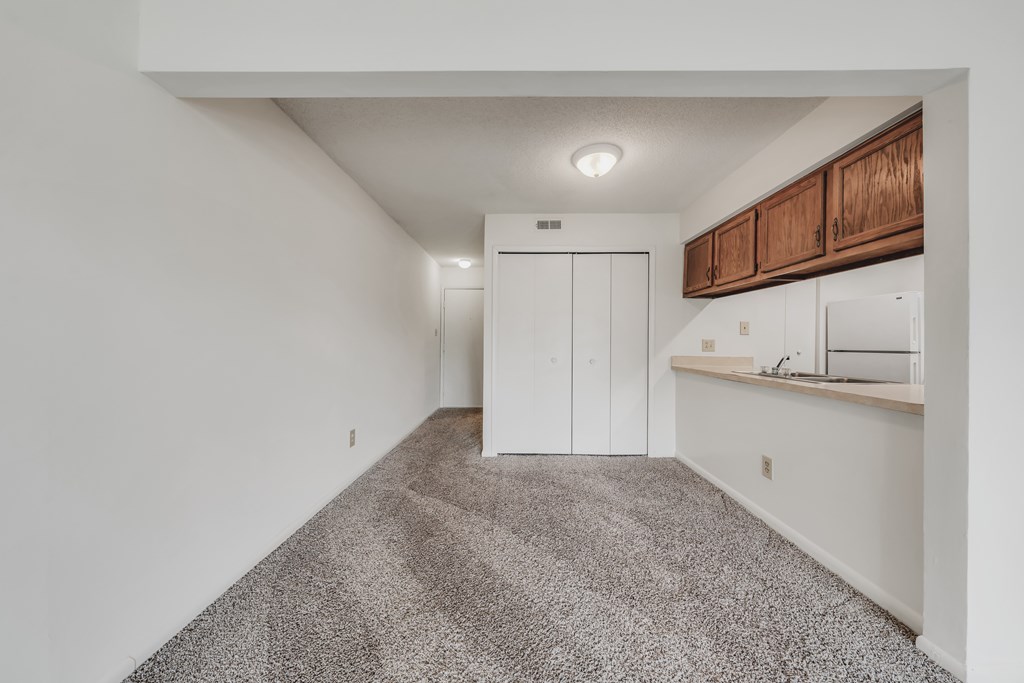 A room with a carpeted floor and a white wall at WaterFront Apartments, Virginia Beach, 23453