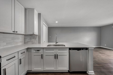 the kitchen of a new home with white cabinets and a sink