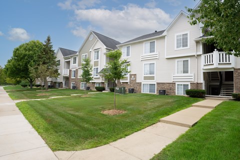 Apartment complex with a green lawn in front.