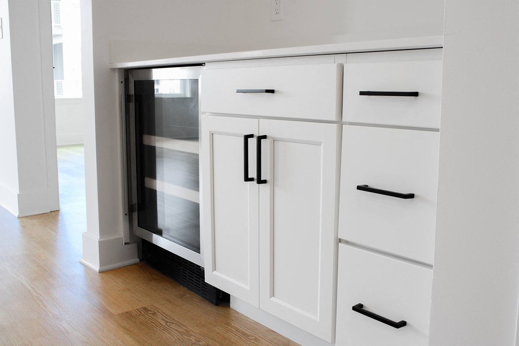 a kitchen with white cabinets and white drawers with black handles  at Avant & Avant II, Carmel, IN, 46032