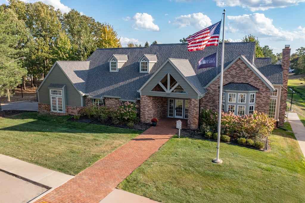 A house with a flag on a pole in front of it.