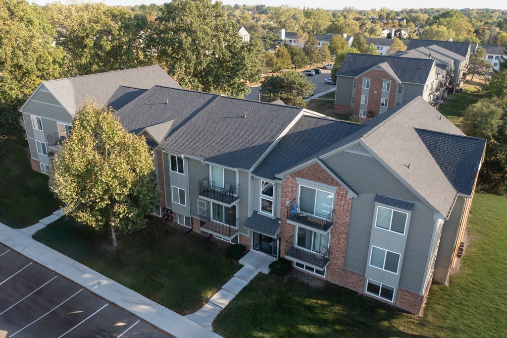 A large building with a parking lot in front.