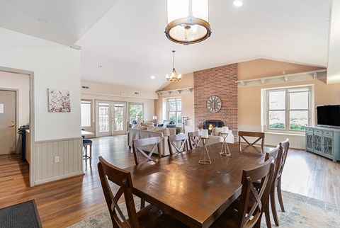 A clubhouse dining room with a wooden table and chairs at Autumn Lakes Apartments and Townhomes, Mishawaka, IN