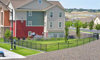 an apartment building with a red and gray garage and a black fence at Badger Canyon, Washington, 99338