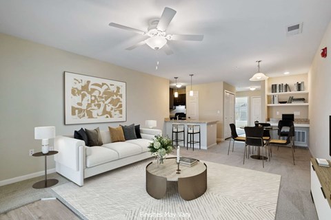 A living room with a white couch, a coffee table, and a painting on the wall.